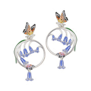 Close-up of Bluebell & Butterfly Hoop Earrings in enamel and rhodium finish by Bill Skinner on white background.