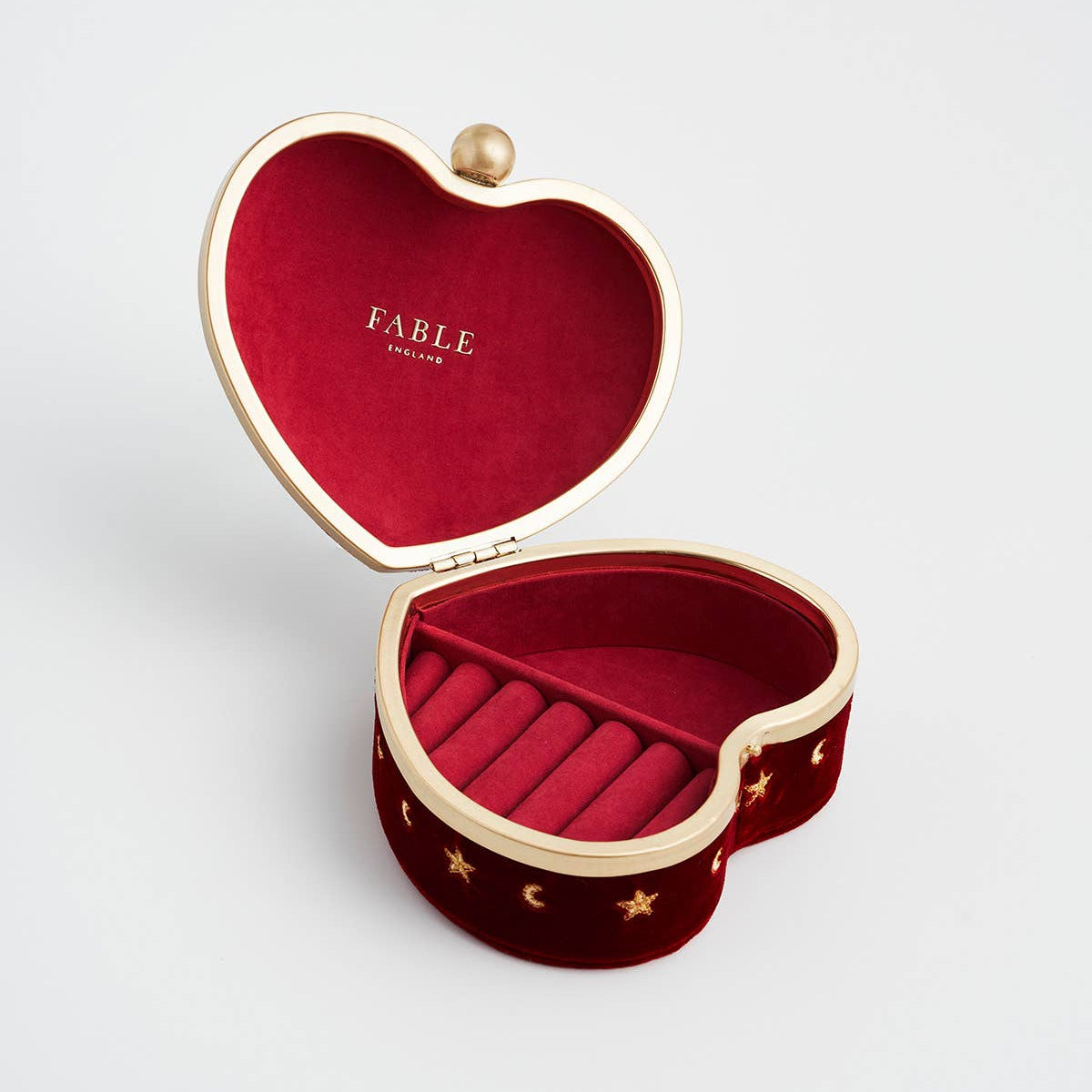 Red velvet heart box open showing the ring roll and lined compartment