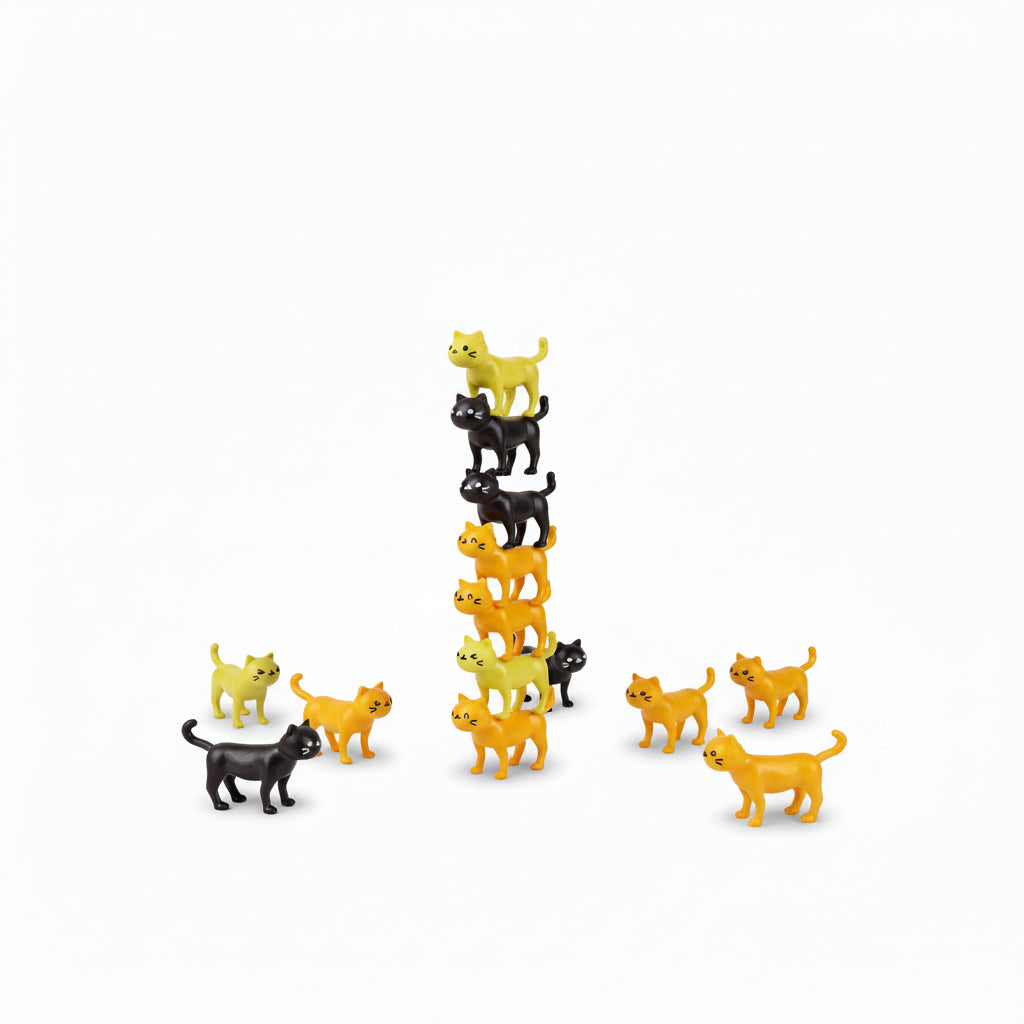 Hand stacking black and yellow cat pieces into a tall tower for Catastrophe game.
