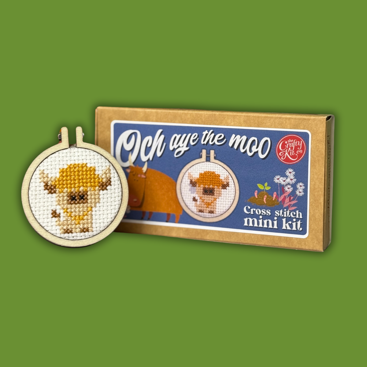 Och Aye The Moo cross stitch kit and finished Highland cow hoop on green