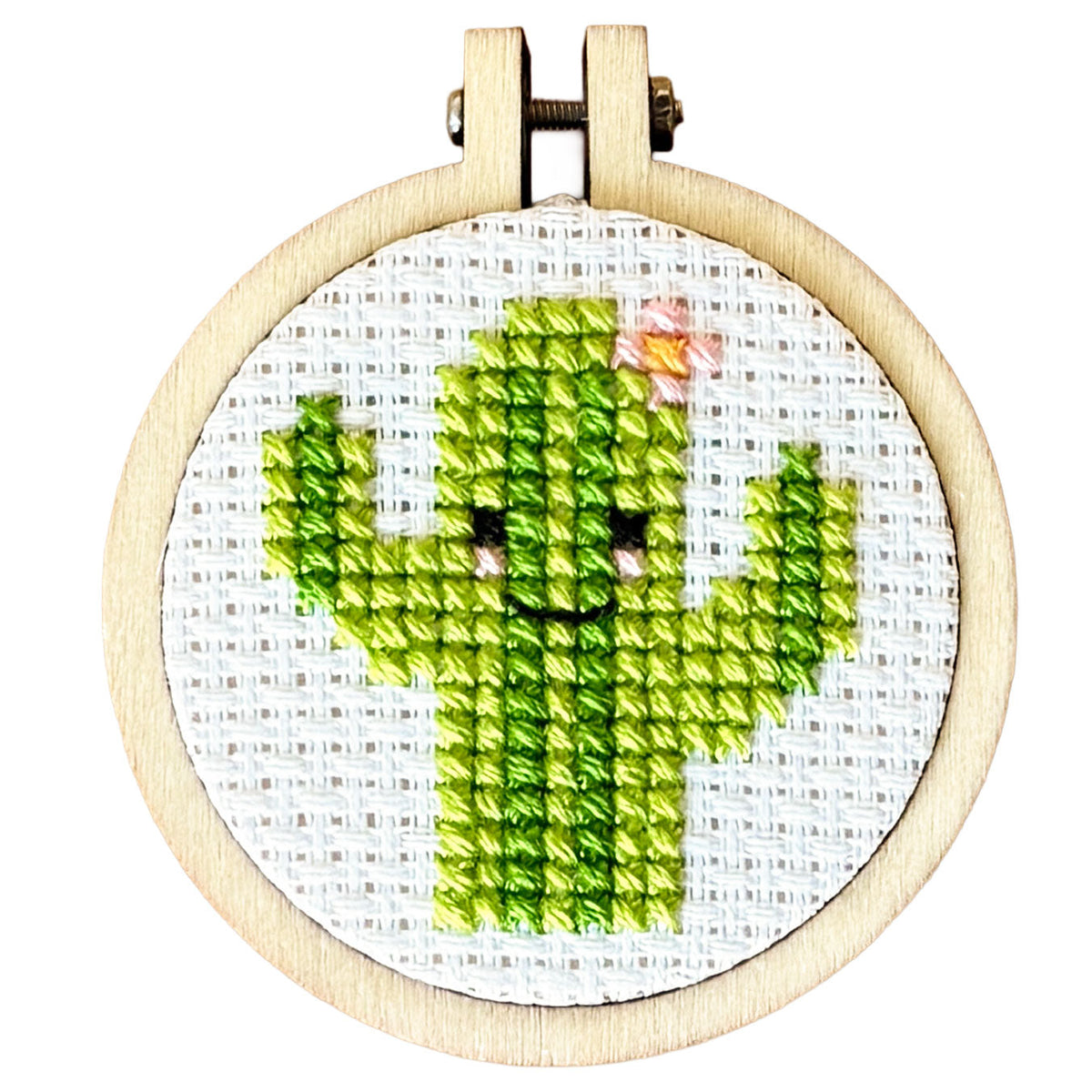 Finished smiling green cactus cross stitch in a 5cm wooden hoop