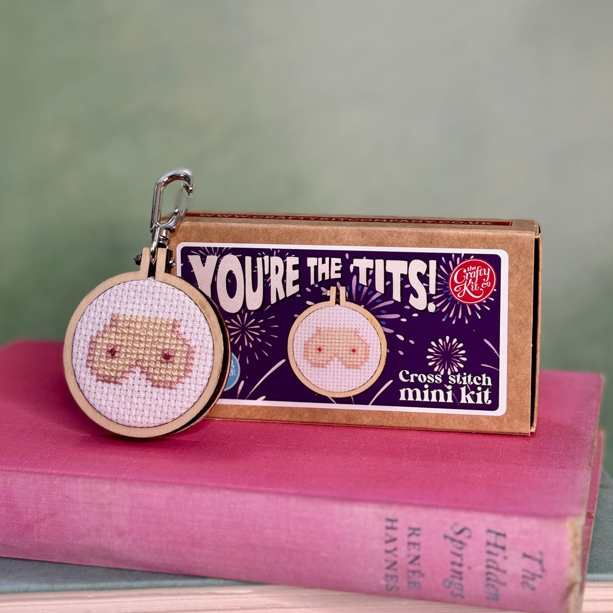 You're The Tits cross stitch keyring and matchbox on a pink book