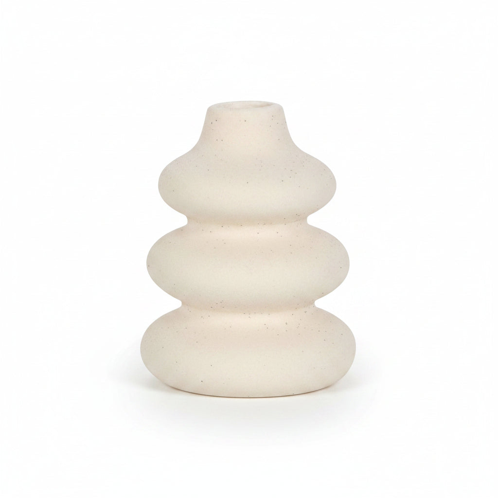 Close-up of cream ceramic vase showing speckled texture and matte finish