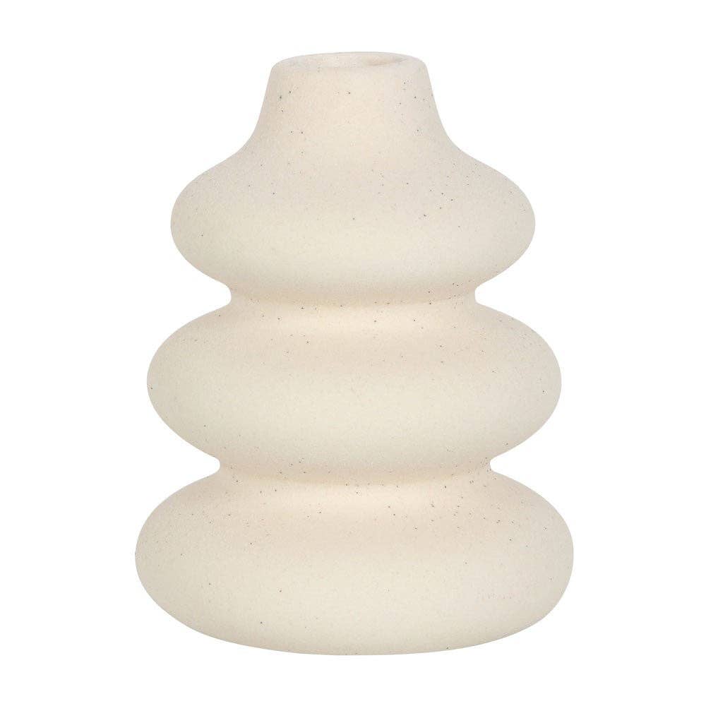 Close-up of cream ceramic vase showing speckled texture and matte finish