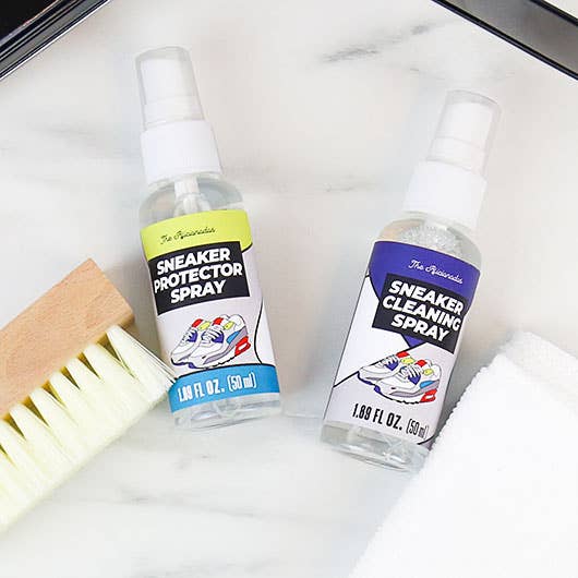 Sneaker protector and cleaning sprays with a wooden brush on marble