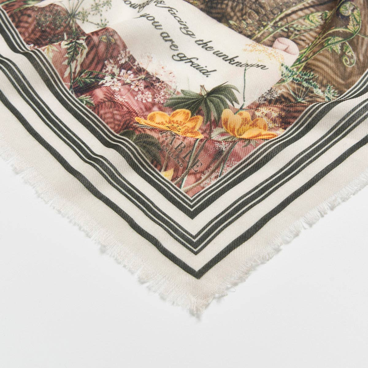 Corner detail of the scarf showing the script text and frayed edge