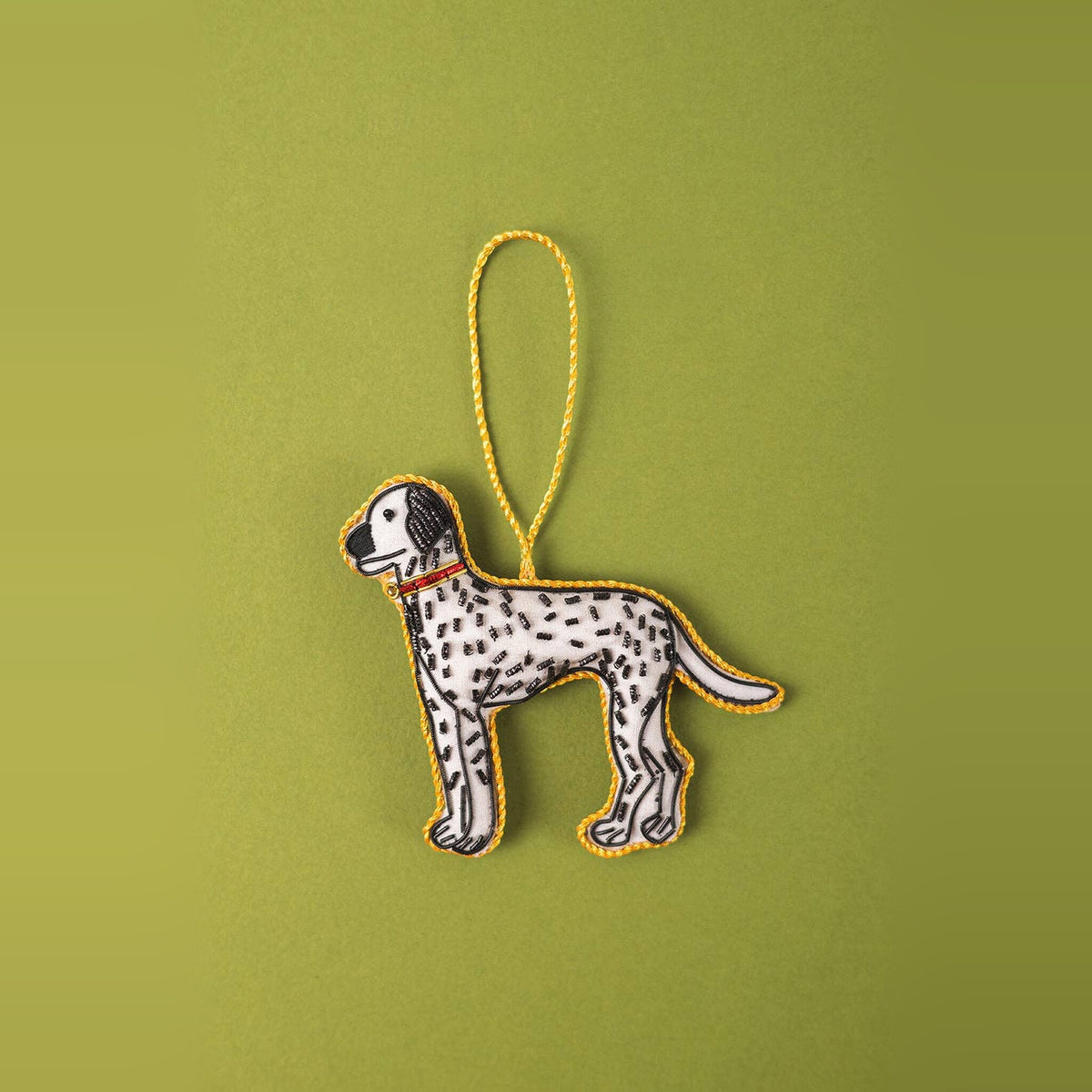 Dalmatian embroidered Christmas decoration, white with black spots and red collar, on a green background