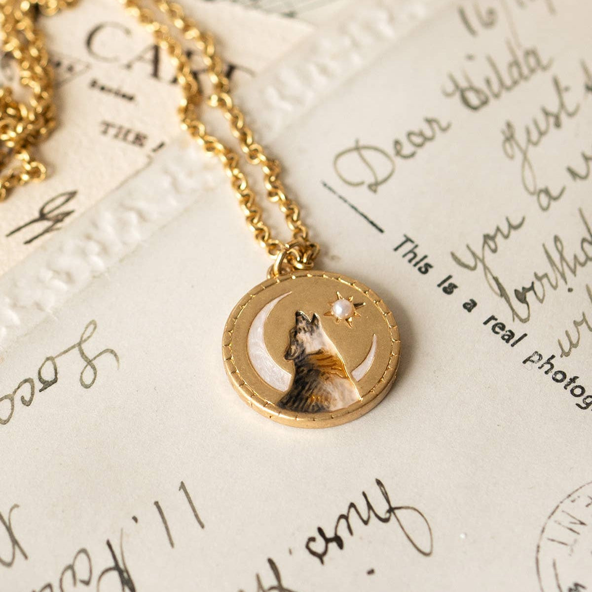 Wolf pendant necklace worn on a model