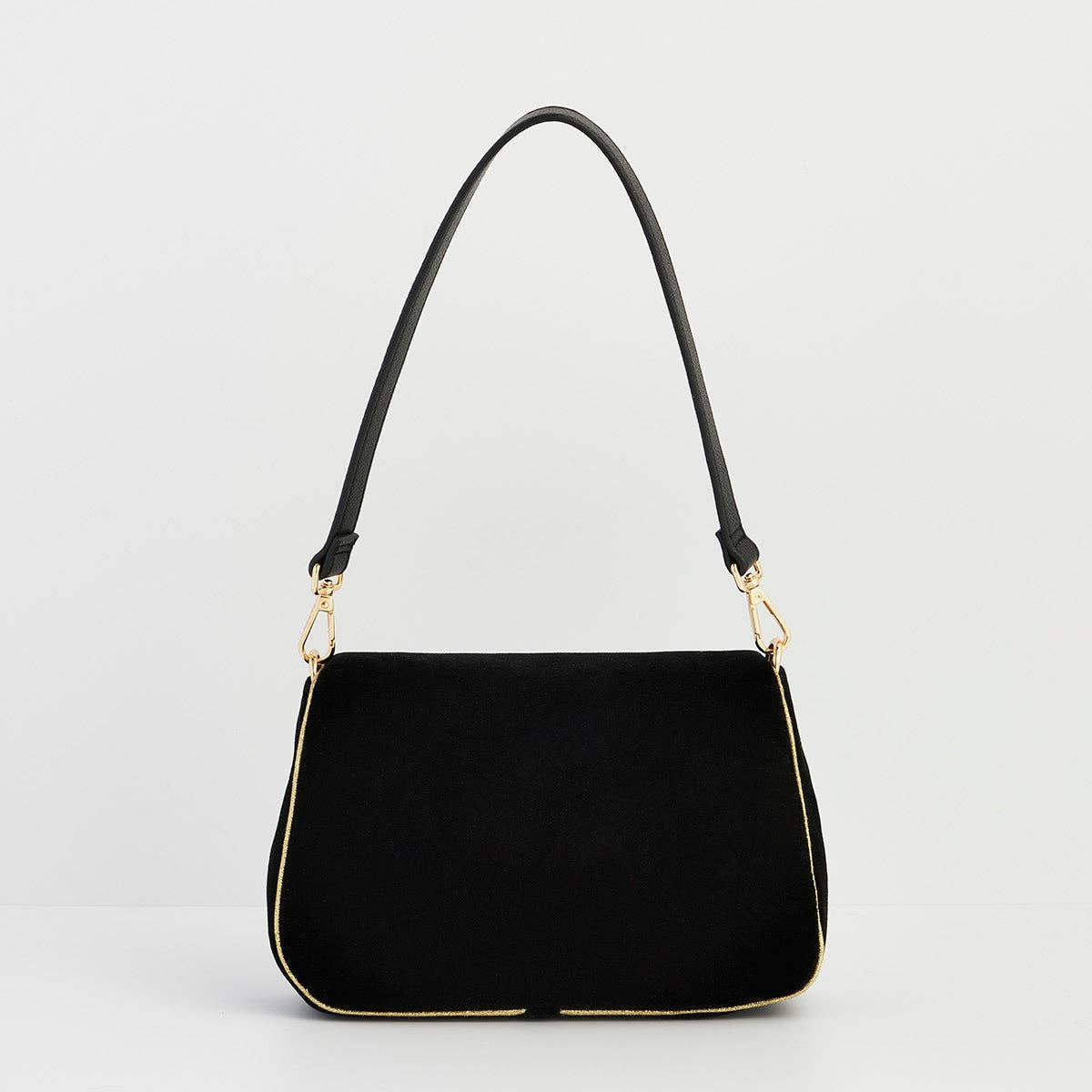 Back view of black velvet shoulder clutch on grey background