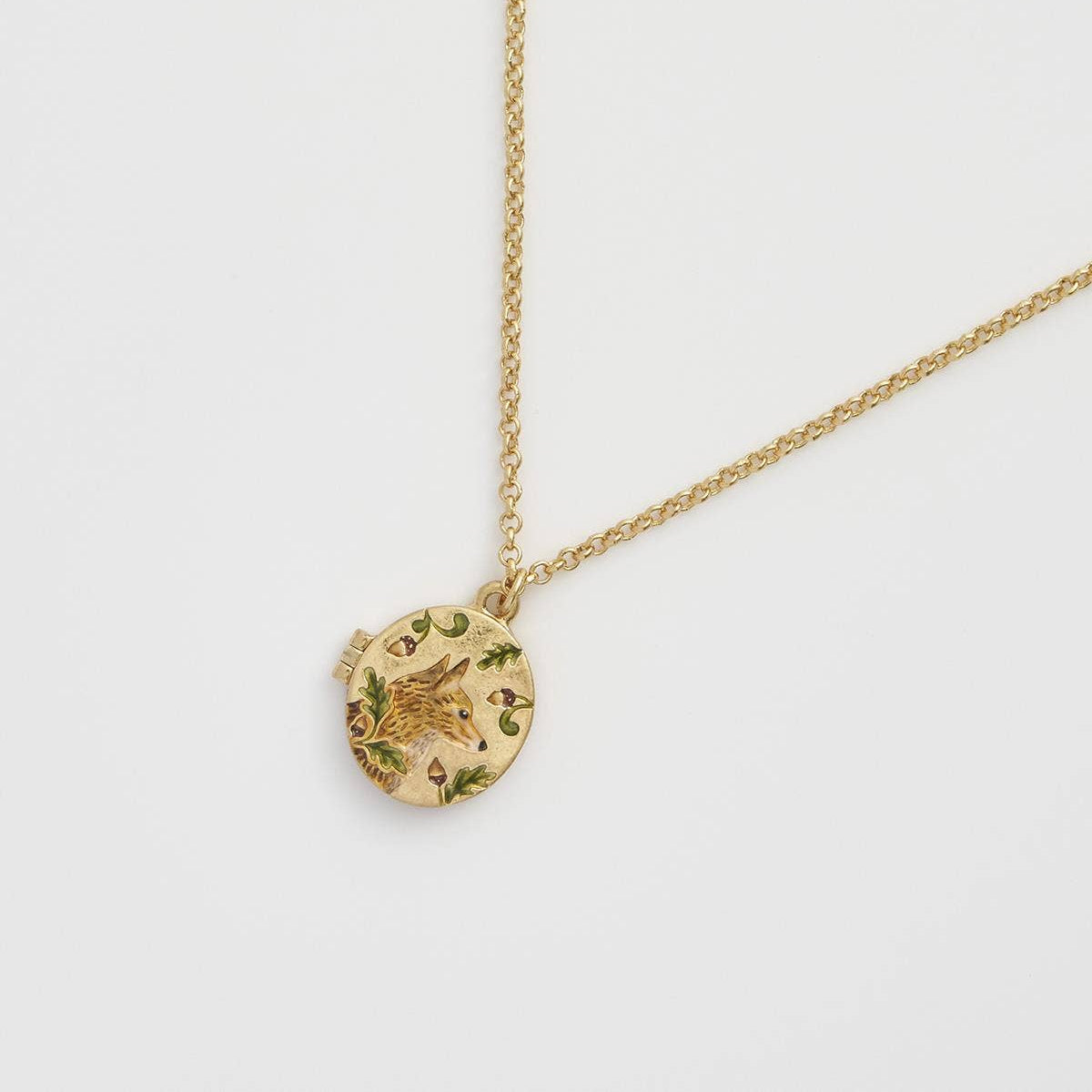 Fox and Acorn gold locket necklace closed on chain - angled view