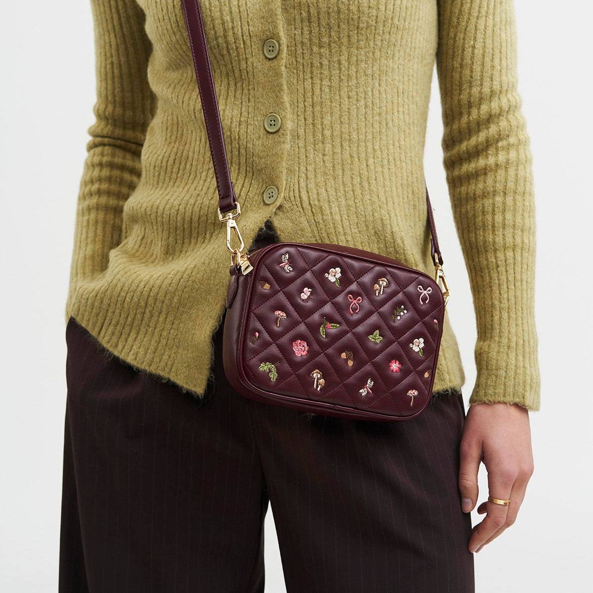 Model wearing the Alice Orla burgundy camera bag crossbody