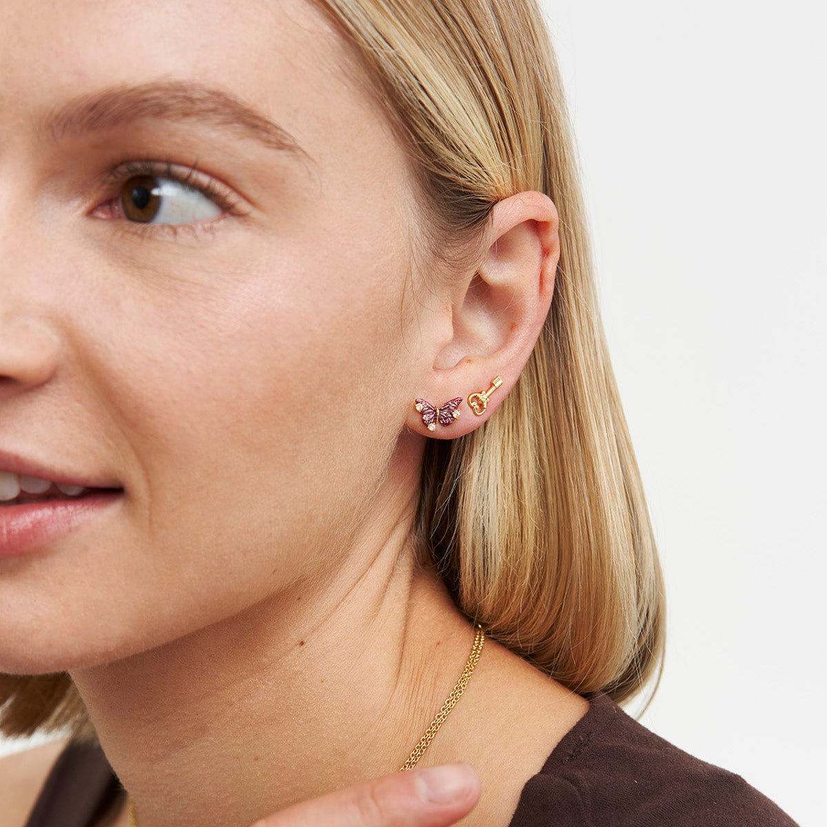 Eve butterfly stud earring worn by a model