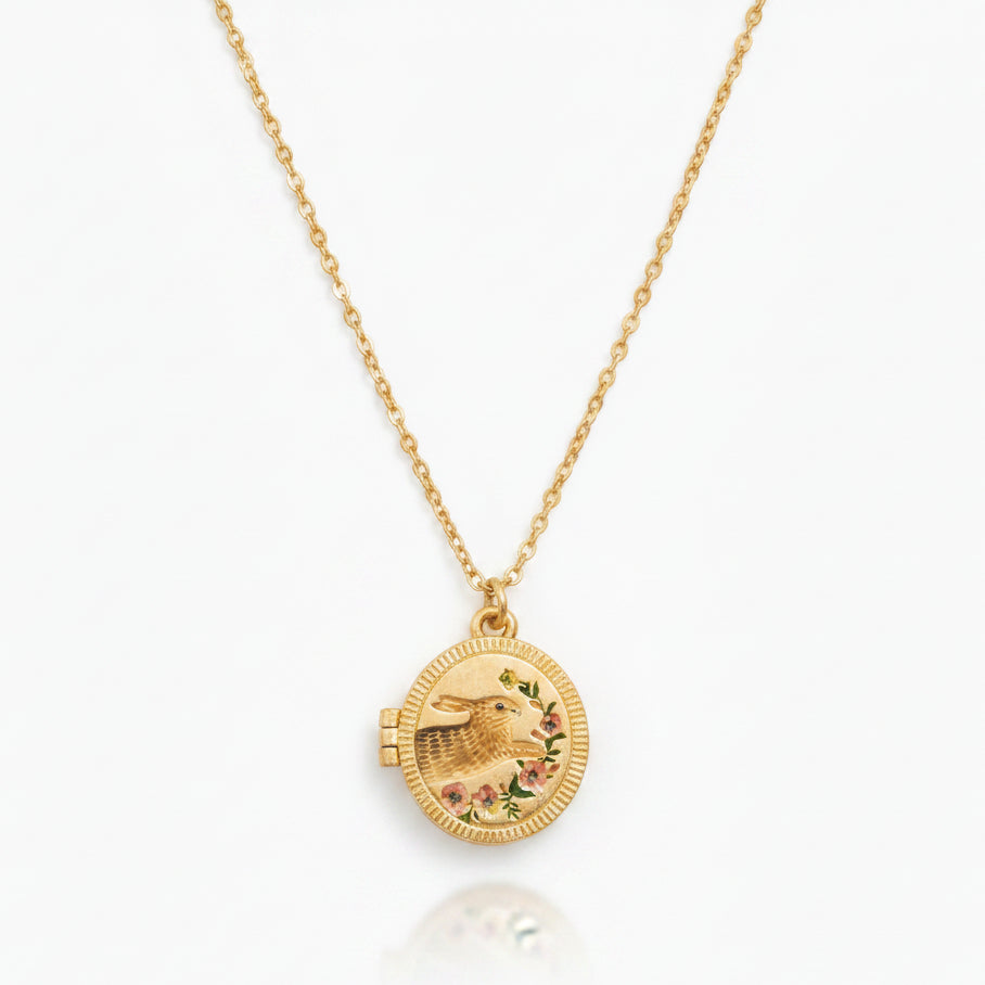 Fable England running bunny locket necklace in gold on white background