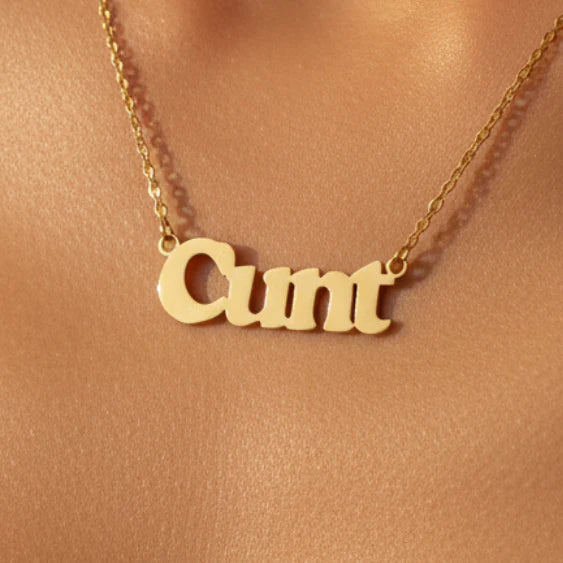 Gold cunt necklace worn around neck on model
