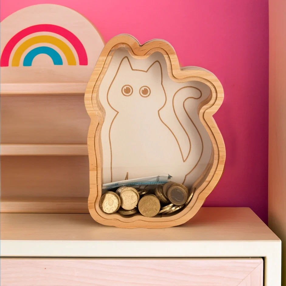 Cat money box on a pale sideboard below a rainbow wall decoration