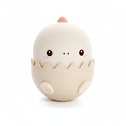 Pink dinosaur-shaped night light with a soft glow