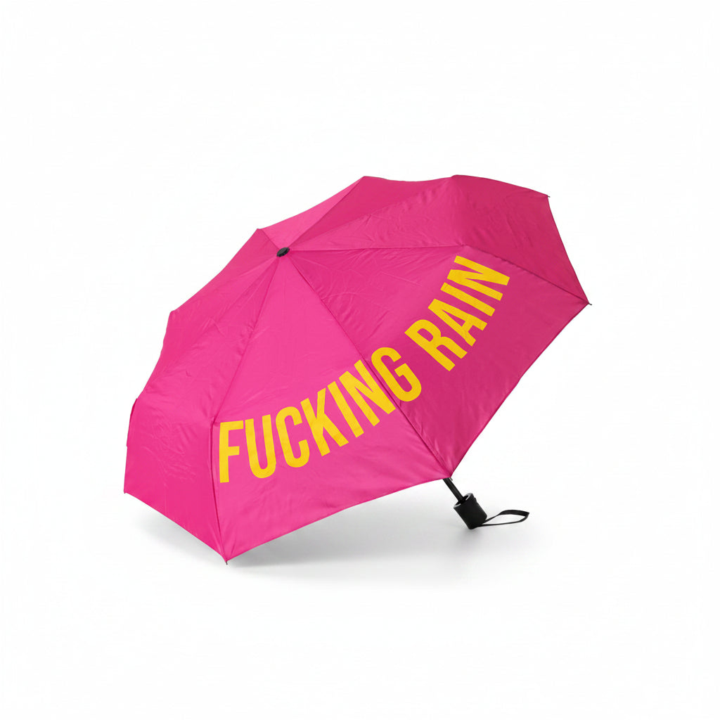Pink folding umbrella open, printed with yellow F*cking Rain lettering