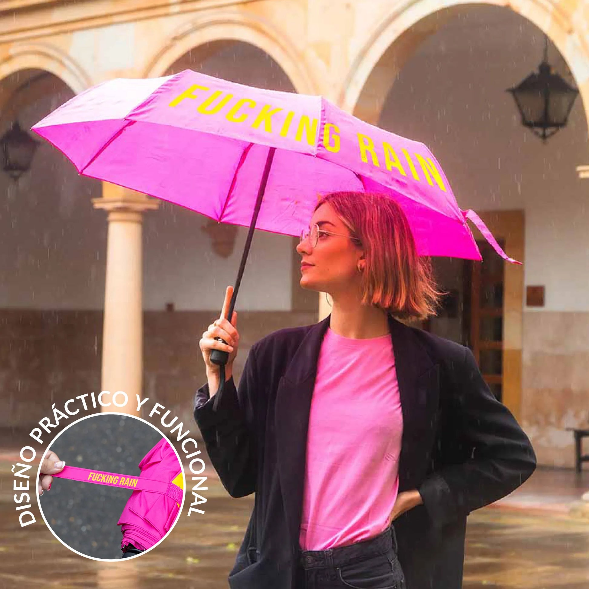 Woman in pink carrying the open umbrella under a stone archway