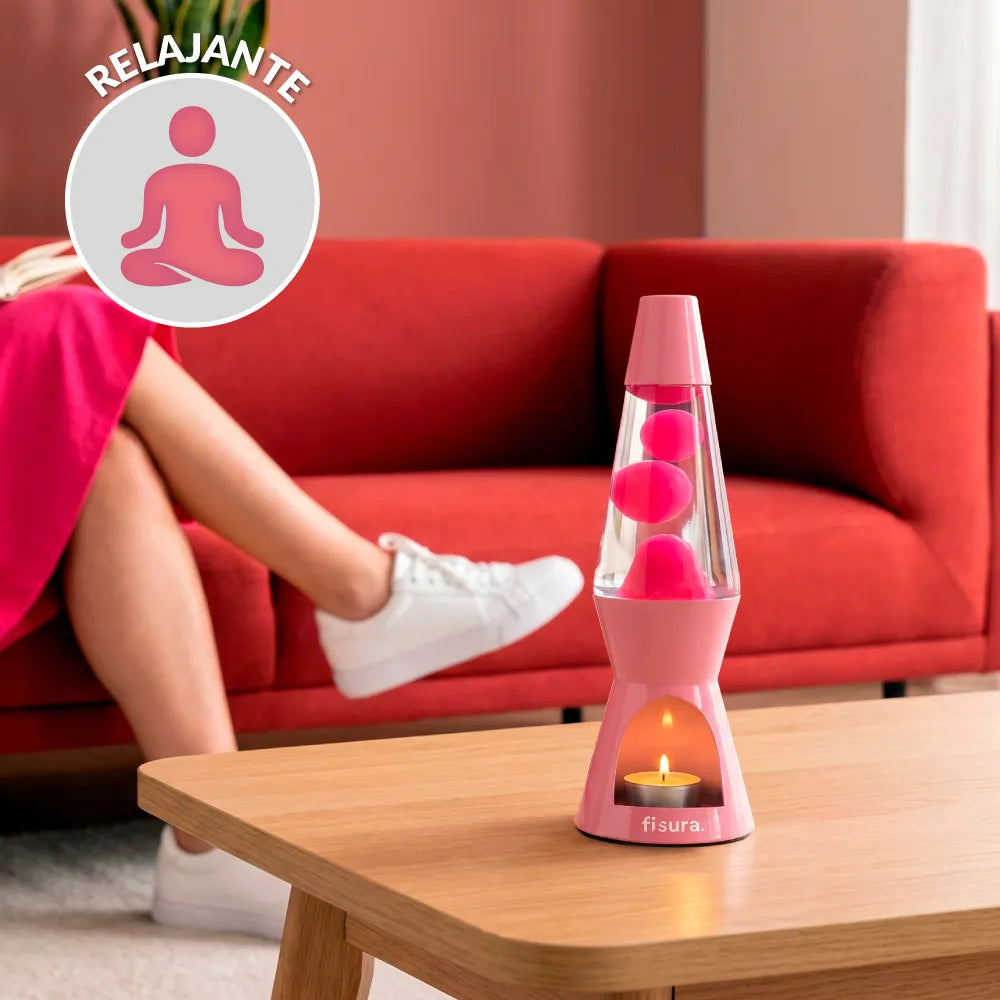 Pink lava candle lamp glowing on a table beside a red sofa