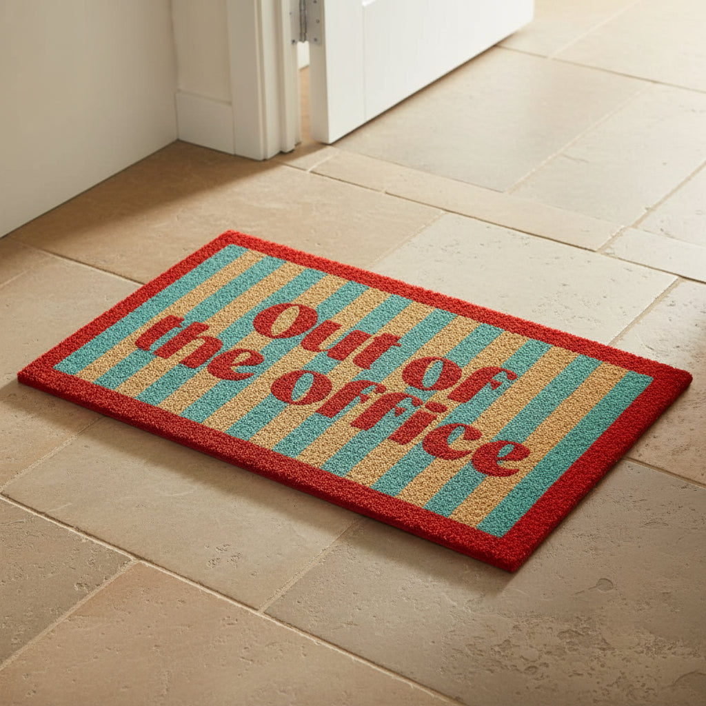 Out Of The Office striped coir doormat with a red border, seen from above
