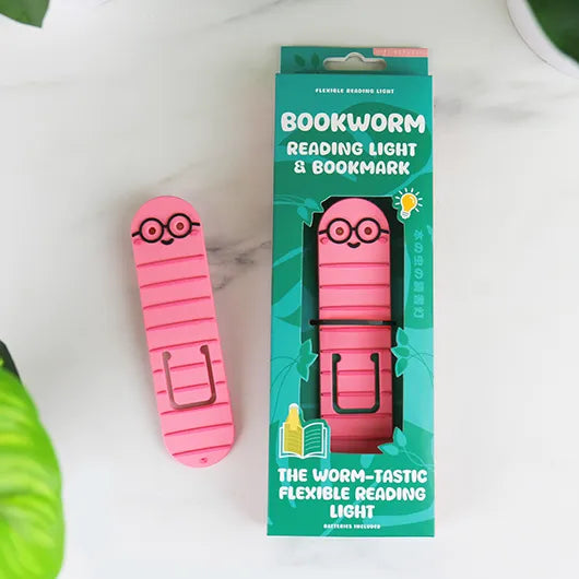 Bookworm reading light beside its green packaging on marble