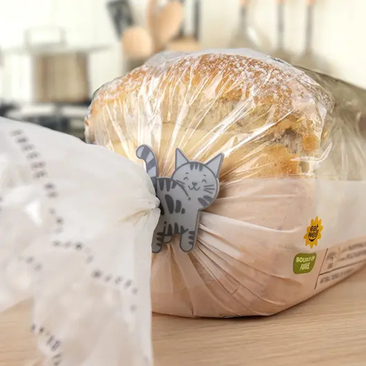 Cat shaped clip sealing a bread bag on a kitchen counter