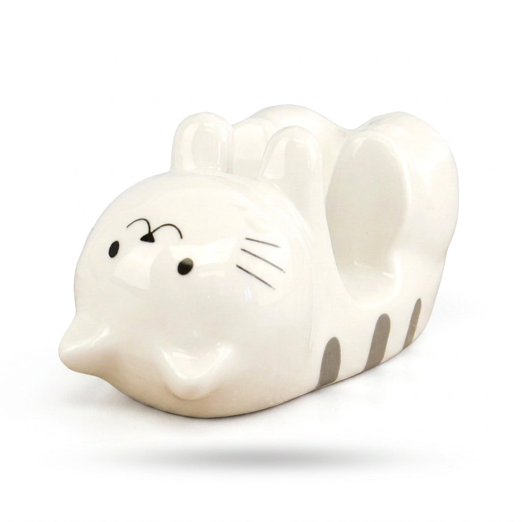 White ceramic cat phone stand with grey stripes on a white background