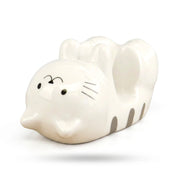 White ceramic cat phone stand with grey stripes on a white background