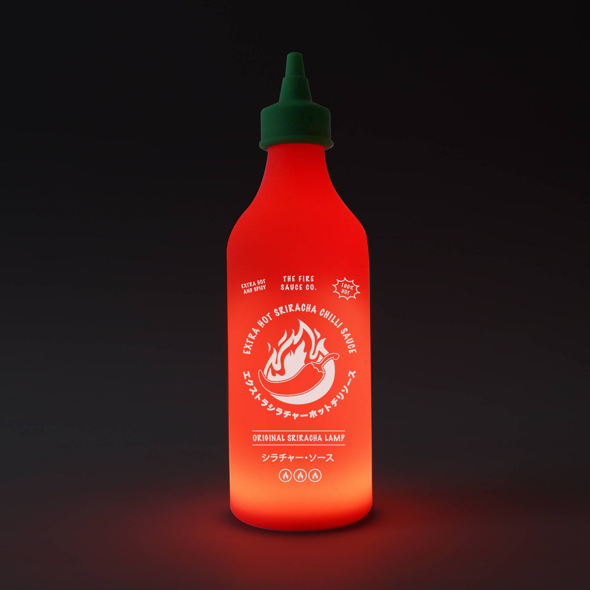 Chilli Sauce Lamp glowing red on a dark background