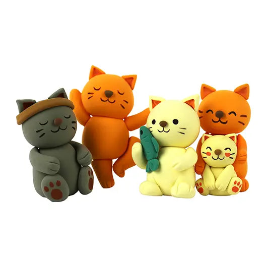 Four handmade air dry clay cats on a white background