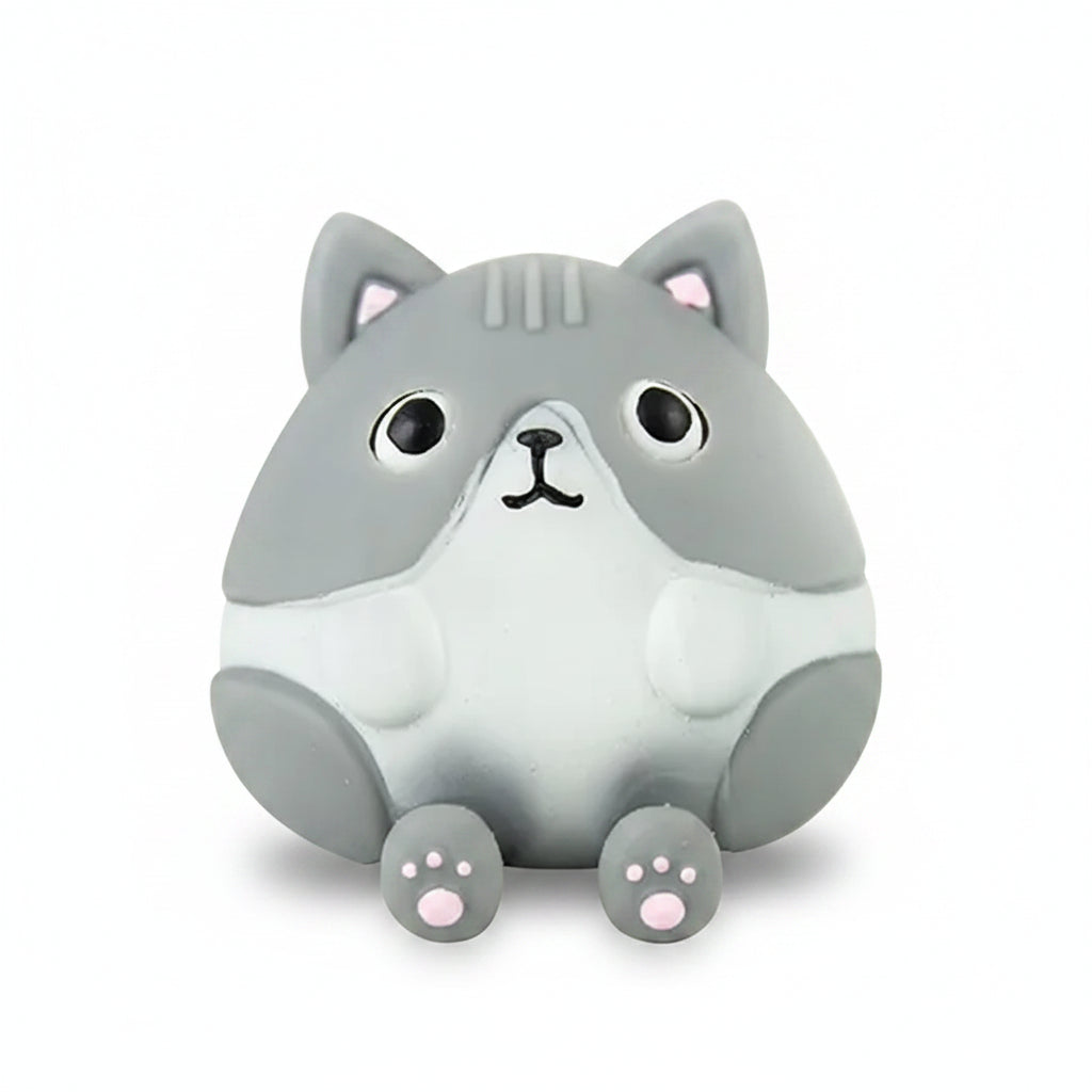 Grey cat stress toy at rest on a bright blue background