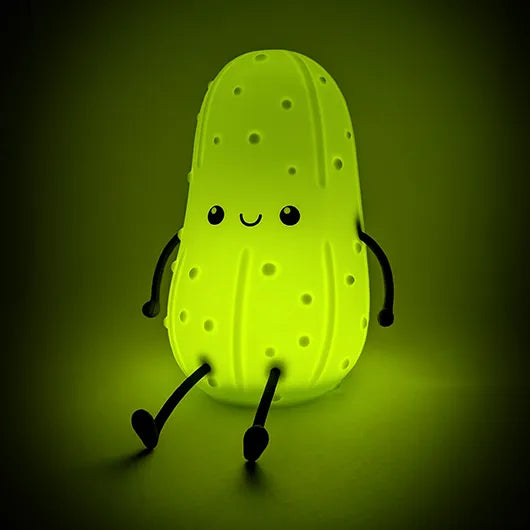 Positive Pickle Light glowing green in a dark room