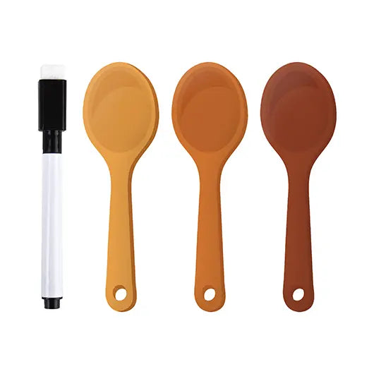 Three spoon-shaped page markers and a wipeable pen on white