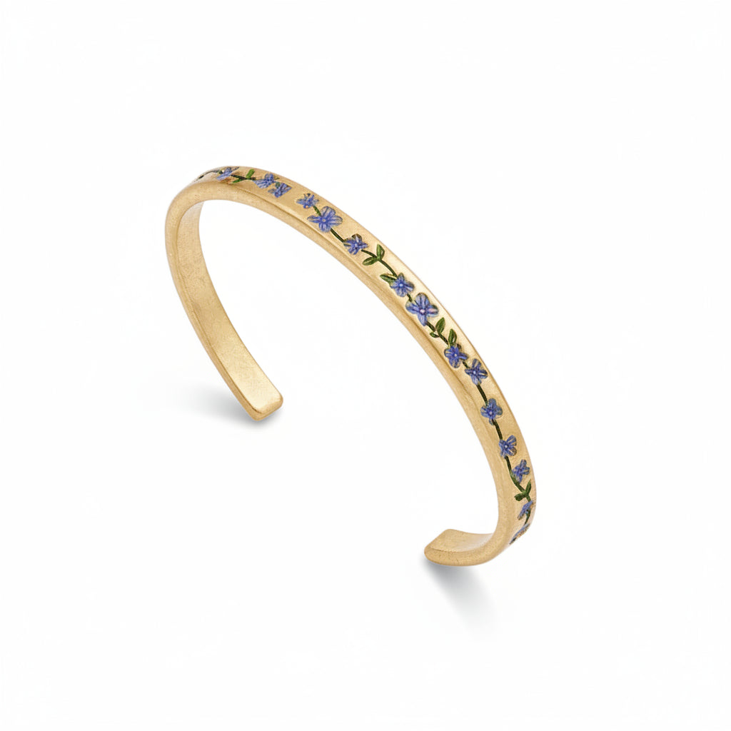 Gold bracelet with floral design on a white background