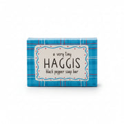 A small rectangular box of Haggis black pepper soap bar, featuring a blue plaid pattern with a white central label that reads 'a very tiny HAGGIS black pepper soap bar'.