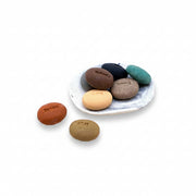 Mood soap pebbles and marbled porcelain dish on a white background
