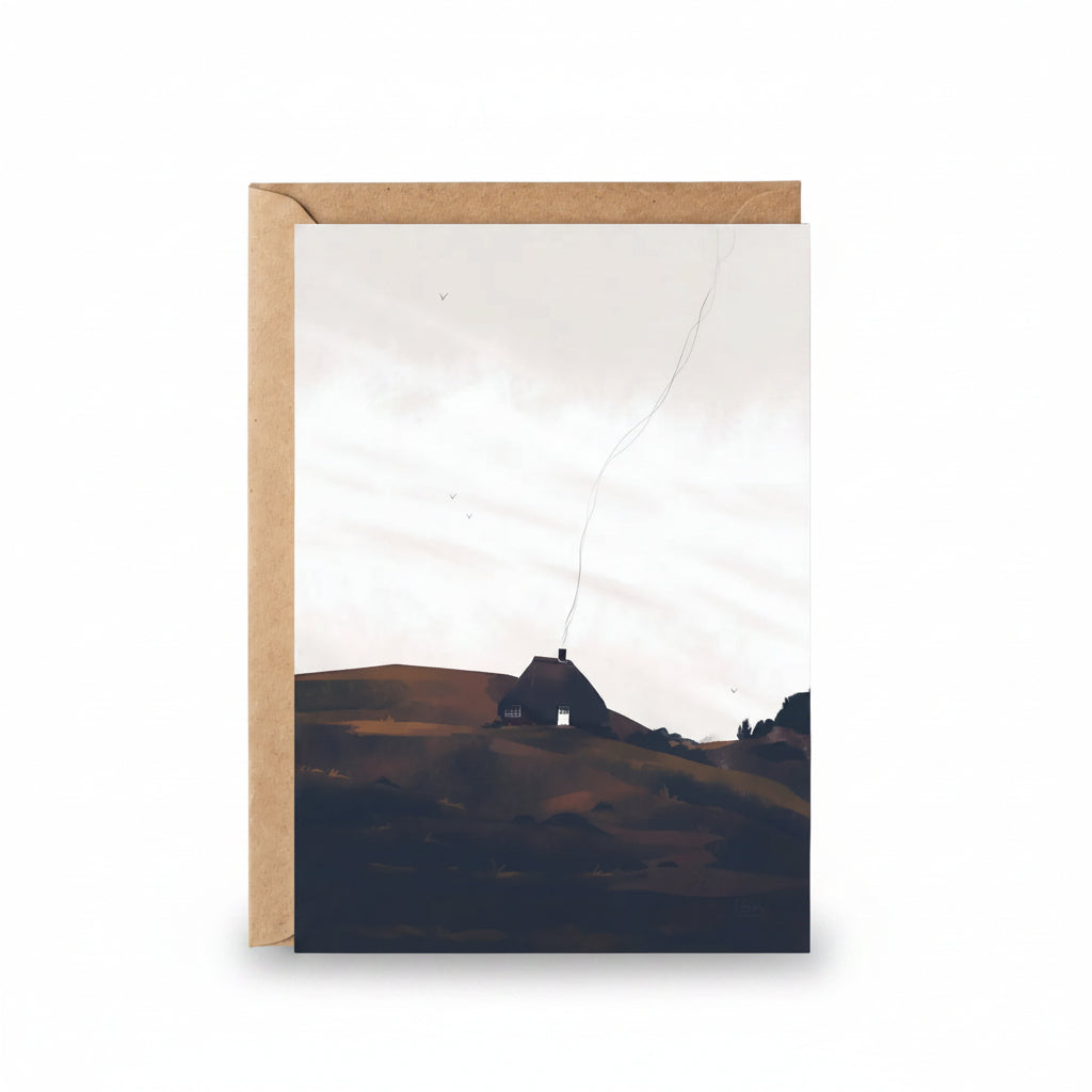 Home in the Borders greeting card featuring illustrated Danish cottage on rolling hills with kraft envelope.