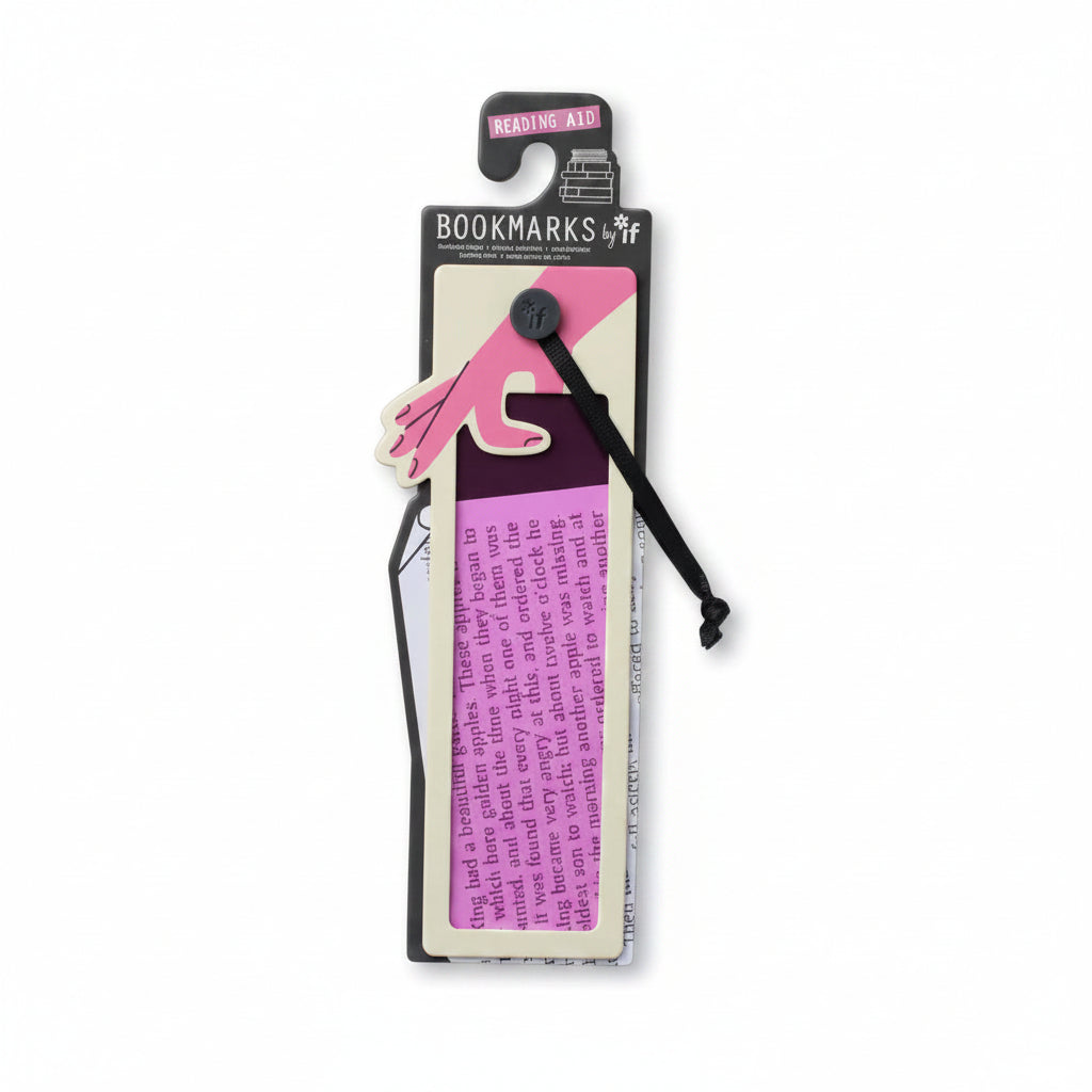 Pink reading aid bookmark and its packaging shown on an open book