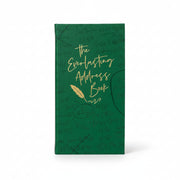 Green address book on a desk with a gold pen and notepaper