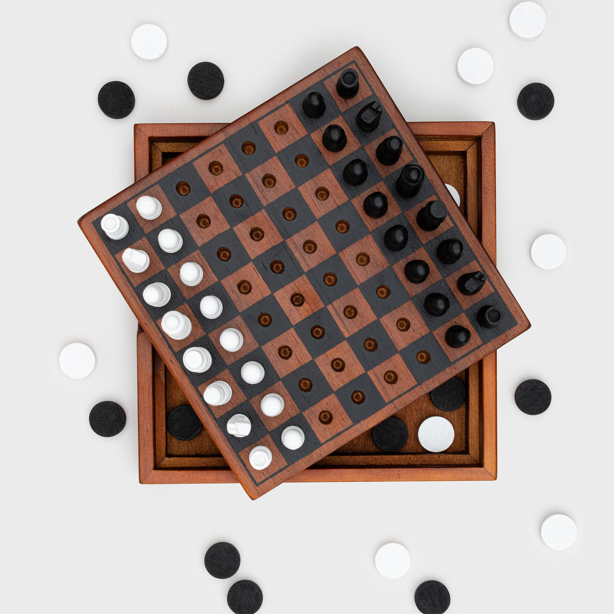 Checkmate wooden board with chess pegs and checkers scattered around