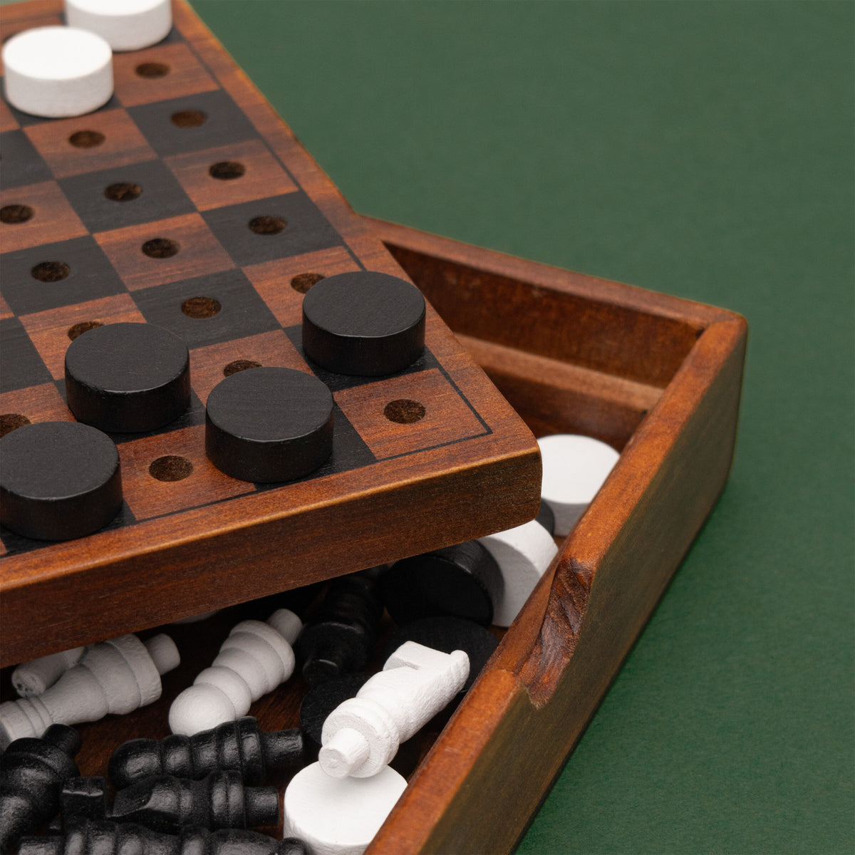 Close up of Checkmate box with chess pieces stored beneath the board lid