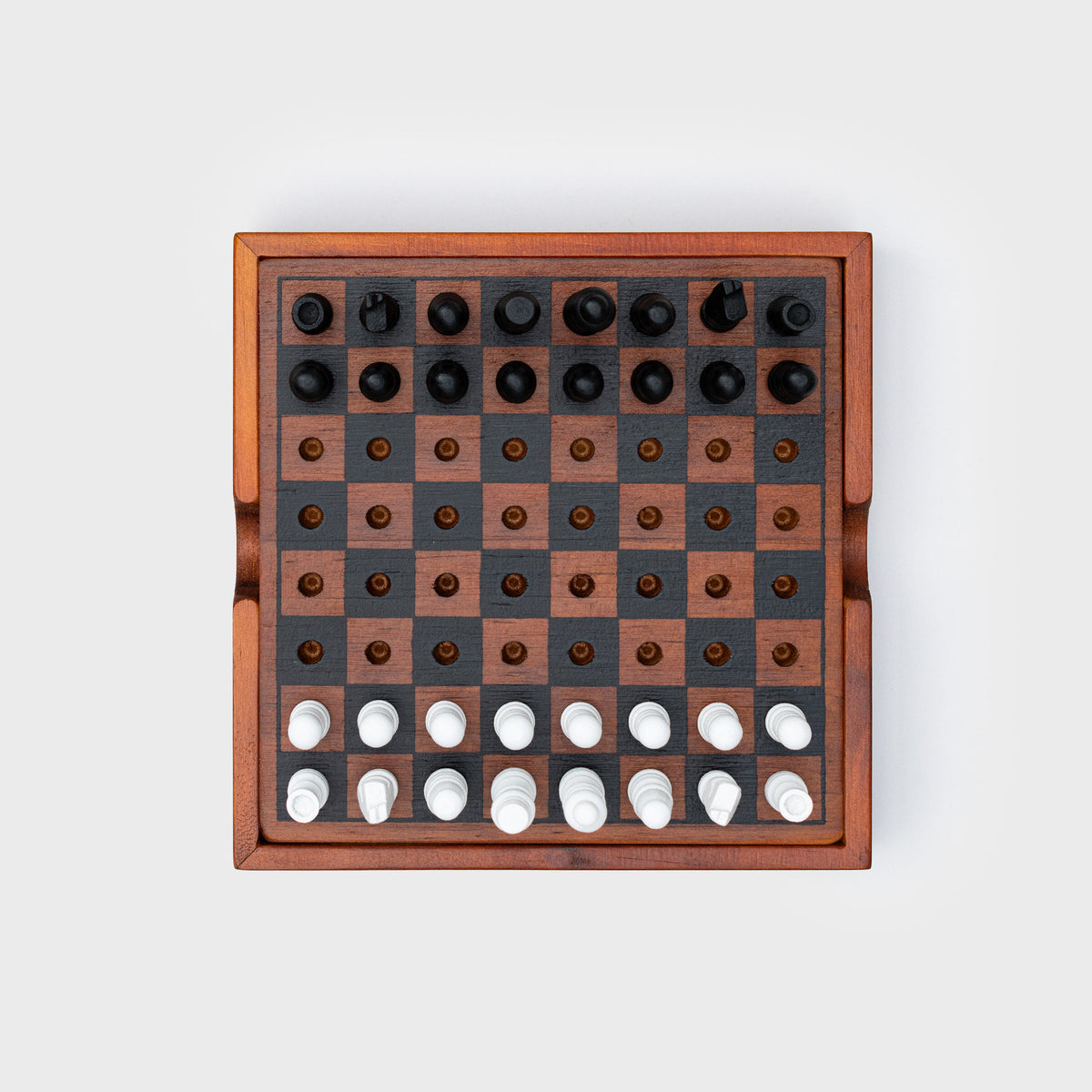 Iron & Glory Checkmate chess set, top down with black and white pieces, grey background