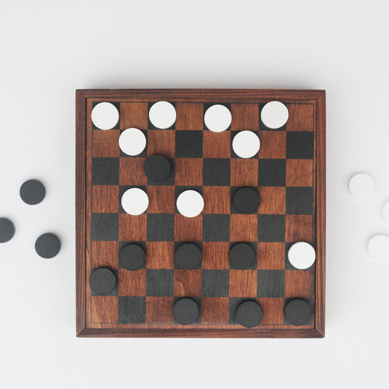 Games Night wooden lid used as a checkers board with black and white pieces