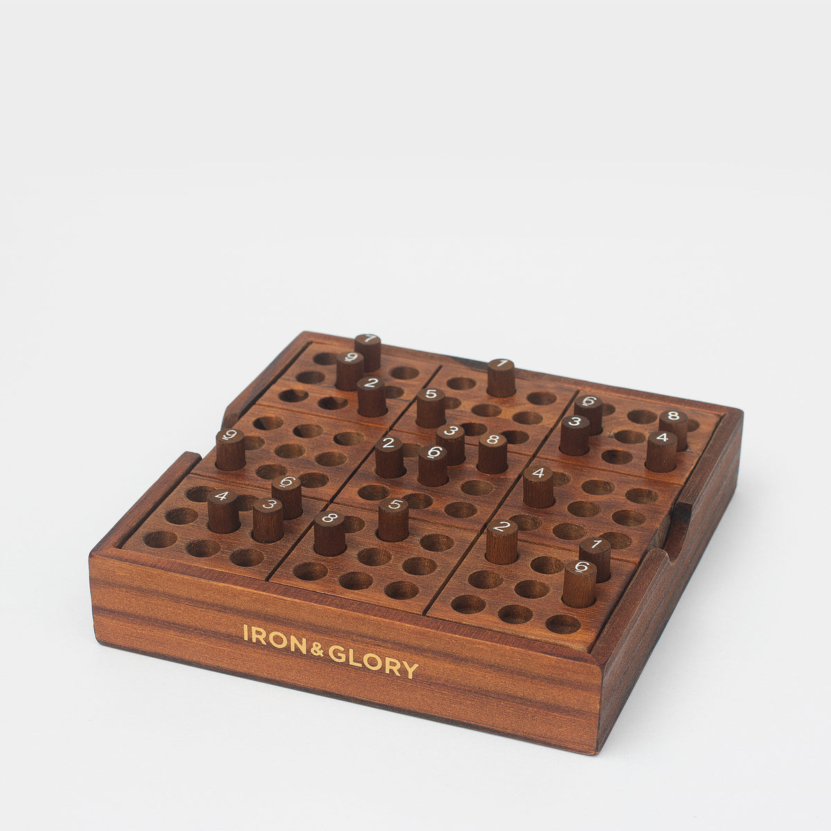 Iron & Glory wooden sudoku board at an angle with gold logo on the side