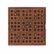 Iron & Glory wooden sudoku board, top down with numbered pegs, grey background