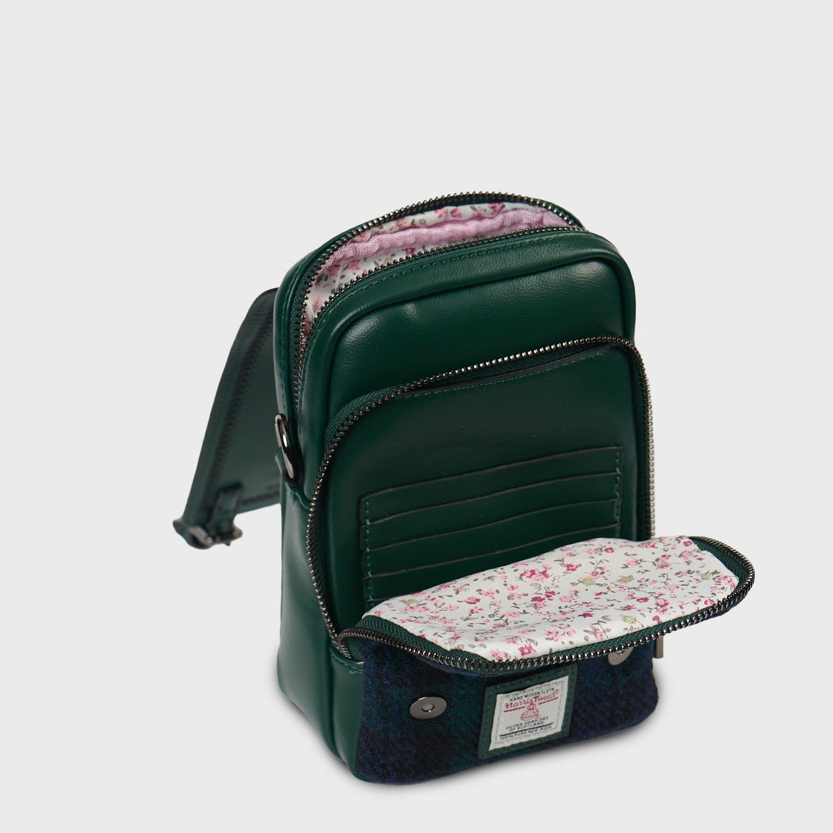 Baby Jura crossbody open showing floral lining and inner compartments