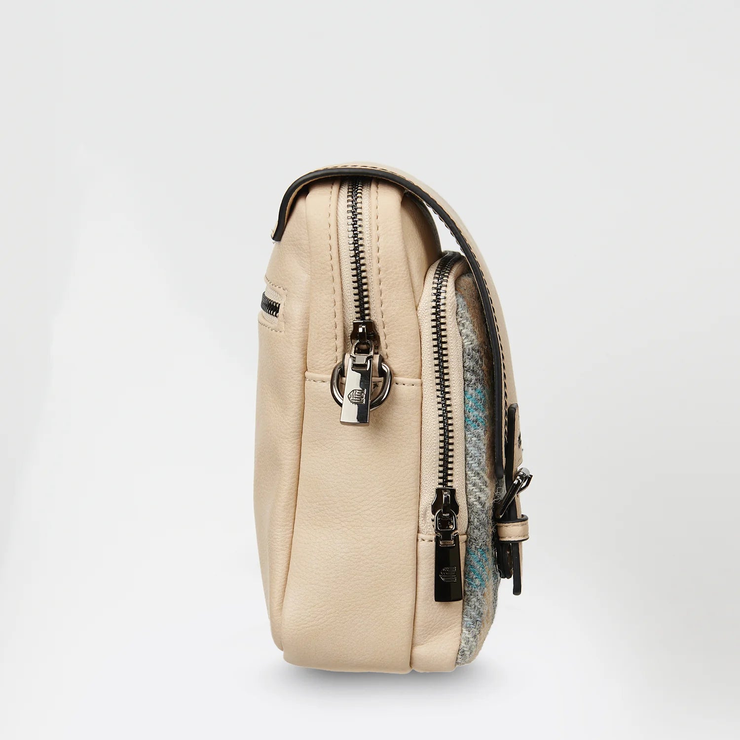 Islander crossbody bag side view showing grey tweed panel and zip pocket