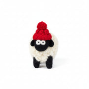 Hand-knitted wool sheep figure wearing a red bobble hat