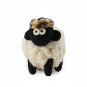 Handmade wool sheep collectible wearing a yellow tartan flat cap