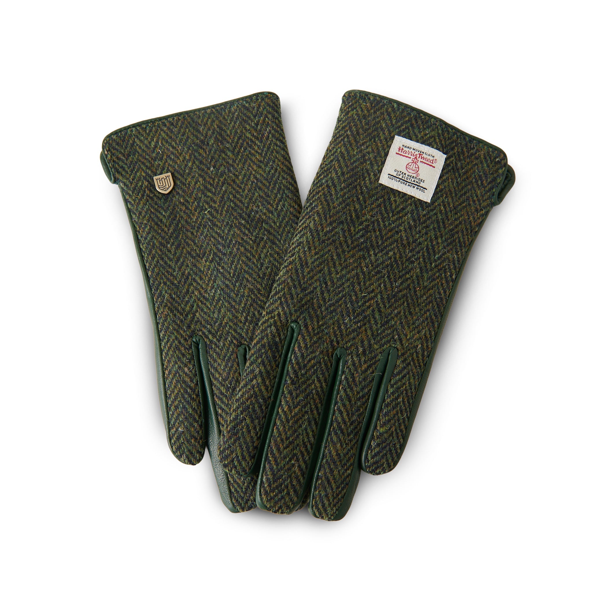 Dark green herringbone Harris Tweed glove gripping walking stick on Scottish hillside